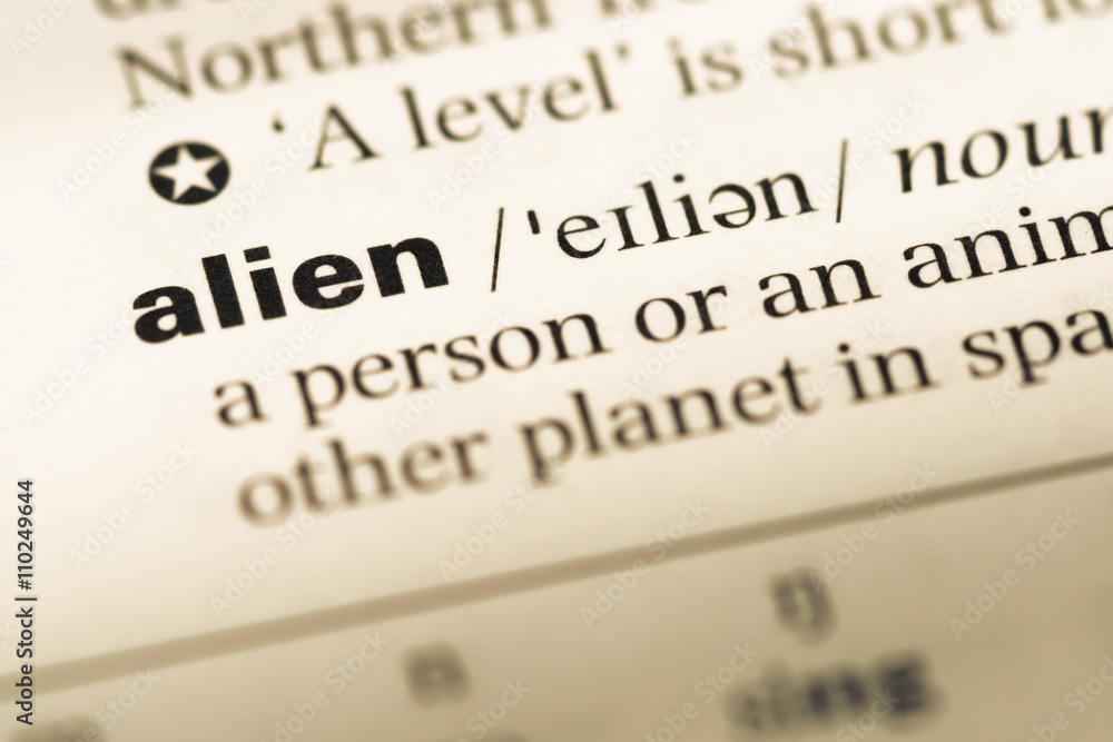 Close up of old English dictionary page with word alien Close up of old English dictionary page with word alien