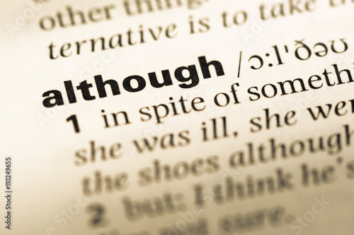 Close up of old English dictionary page with word although