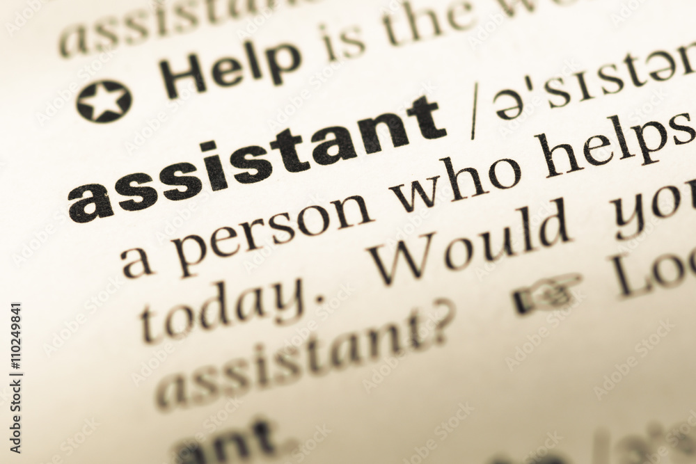 Obraz premium Close up of old English dictionary page with word assistant