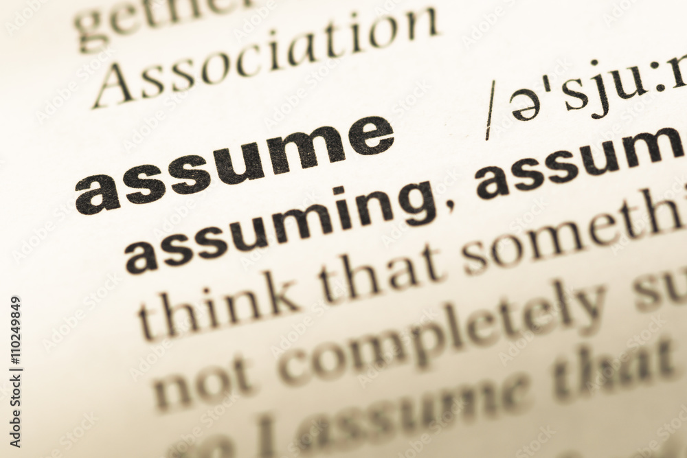 Close up of old English dictionary page with word assume Close up of old English dictionary page with word assume