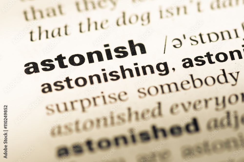 Close up of old English dictionary page with word astonish Close up of old English dictionary page with word astonish