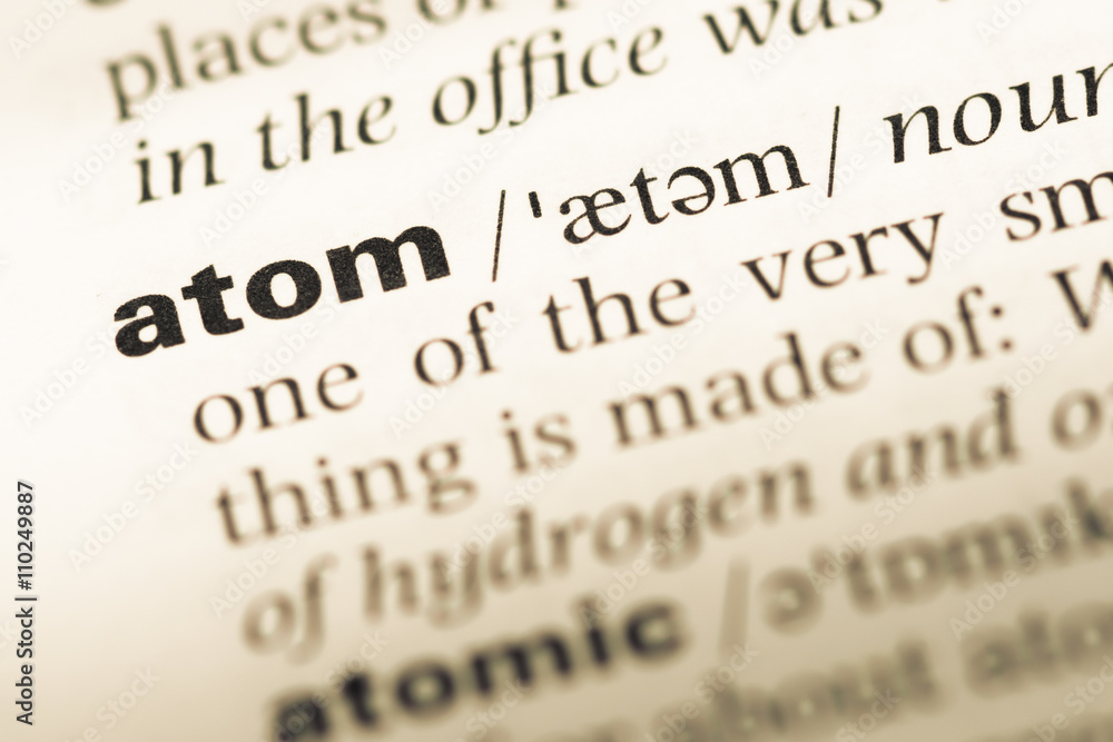 Obraz premium Close up of old English dictionary page with word atom