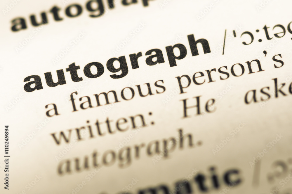 Close up of old English dictionary page with word autograph Close up of old English dictionary page with word autograph