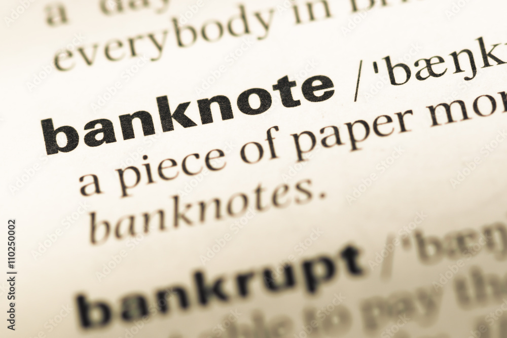 Close up of old English dictionary page with word banknote Close up of old English dictionary page with word banknote