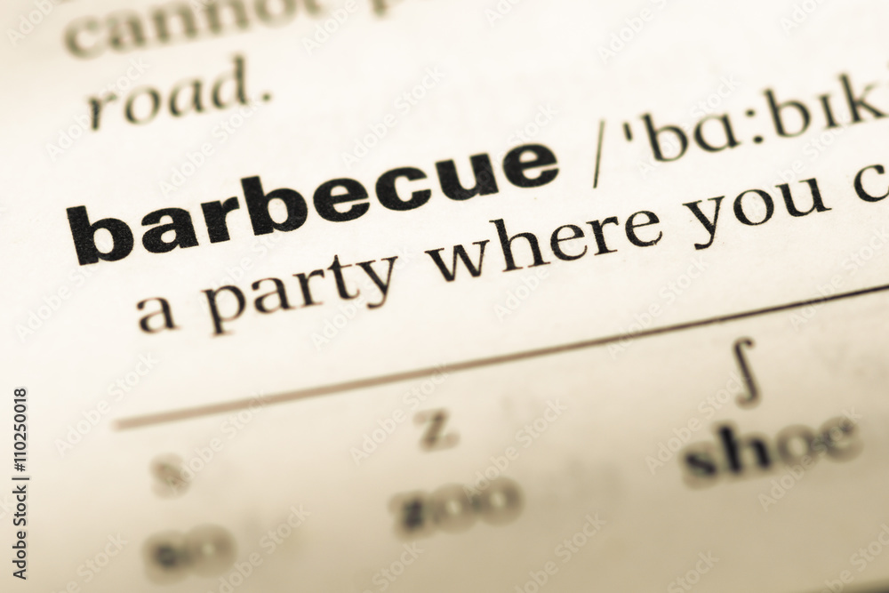 Obraz premium Close up of old English dictionary page with word barbecue