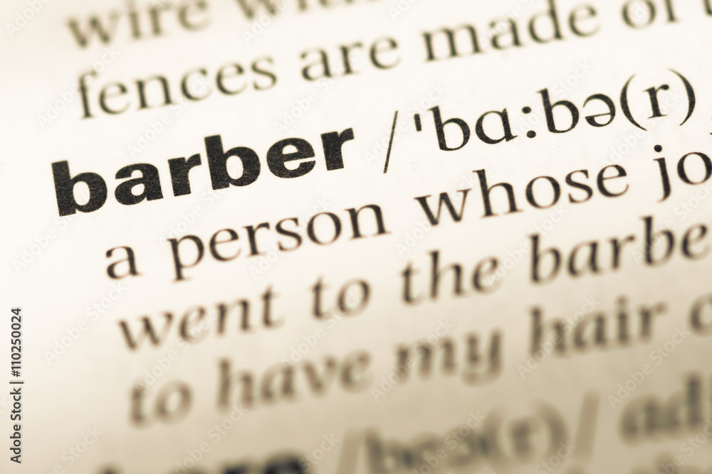 Close up of old English dictionary page with word barber Close up of old English dictionary page with word barber