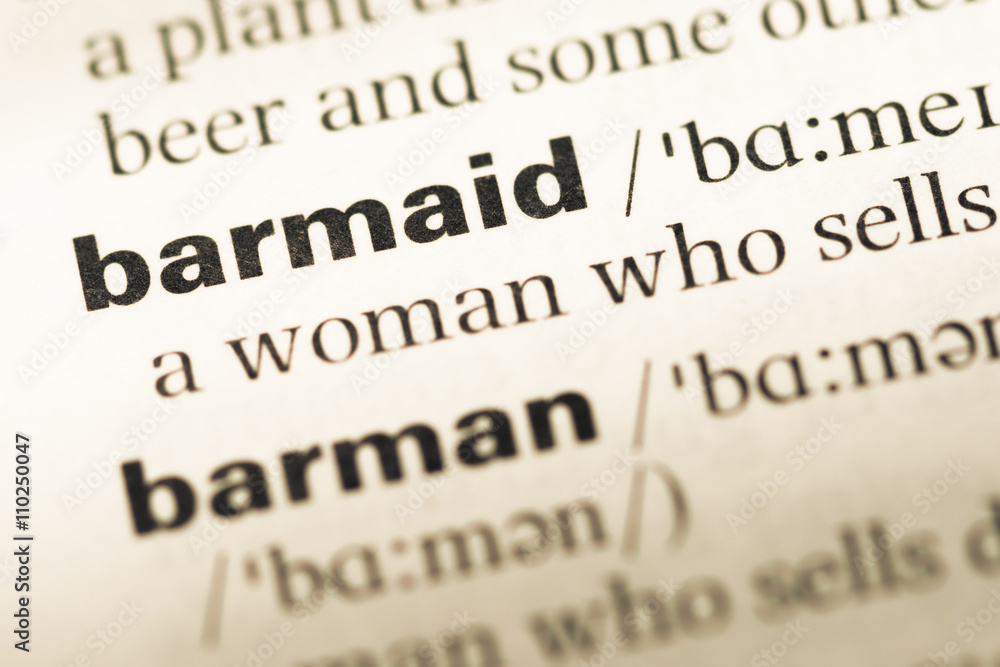 Close up of old English dictionary page with word barmaid Close up of old English dictionary page with word barmaid