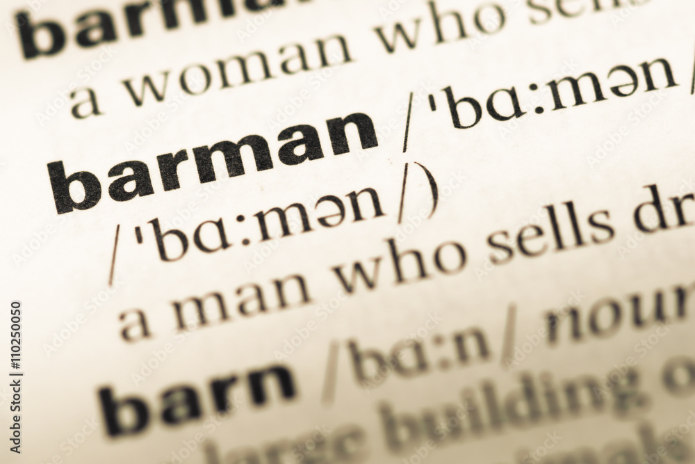 Close up of old English dictionary page with word barman Close up of old English dictionary page with word barman