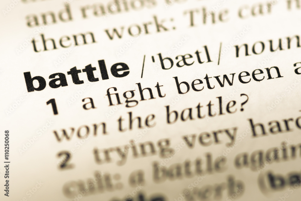 Close up of old English dictionary page with word battle Close up of old English dictionary page with word battle