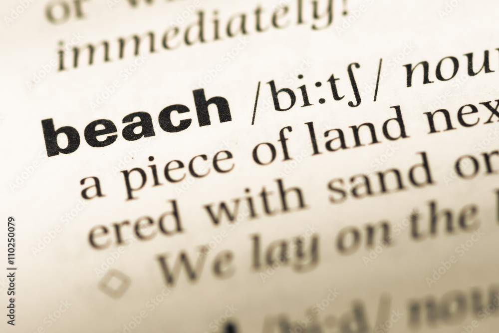 Close up of old English dictionary page with word beach Close up of old English dictionary page with word beach