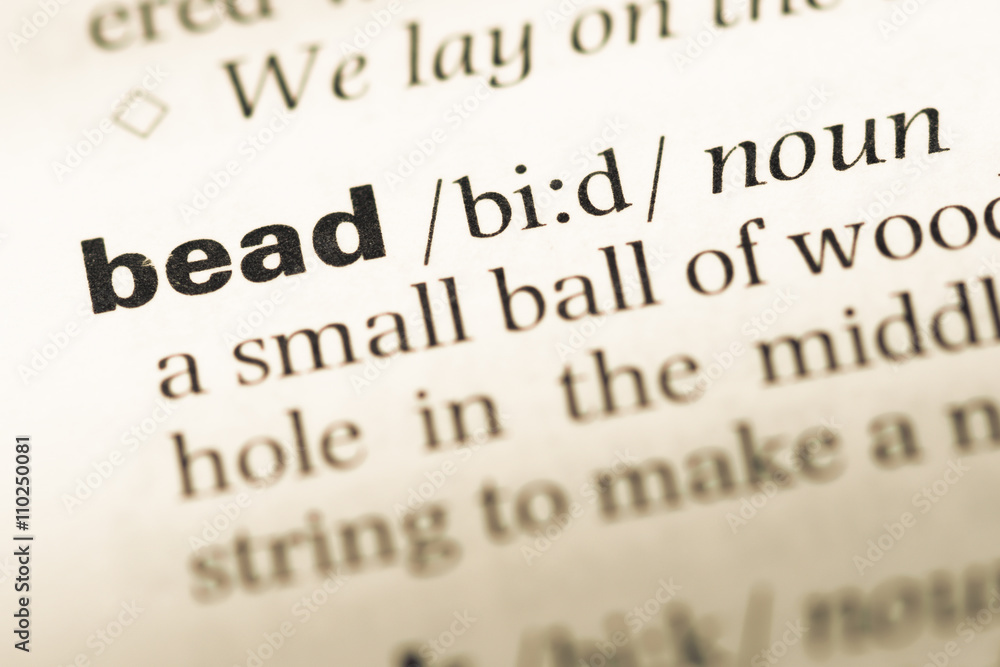 Close up of old English dictionary page with word bead Close up of old English dictionary page with word bead