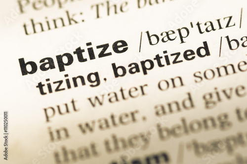 Fotografia, Obraz Close up of old English dictionary page with word baptize