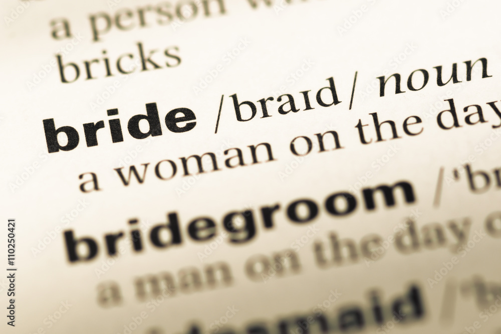 Close up of old English dictionary page with word bride Close up of old English dictionary page with word bride