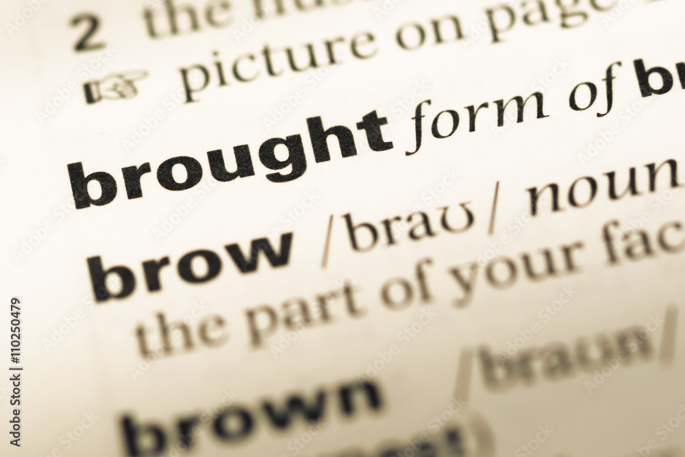 Obraz premium Close up of old English dictionary page with word brought