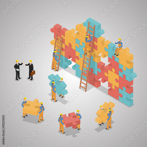 A business team building a puzzle jigsaw. Teamwork business conc