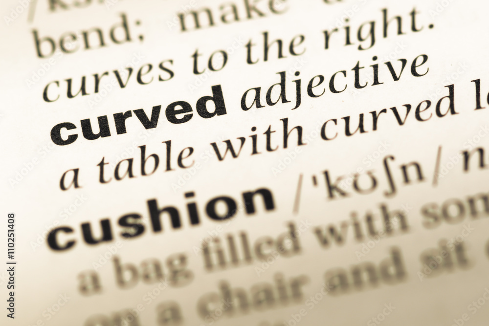 Close up of old English dictionary page with word curved Close up of old English dictionary page with word curved