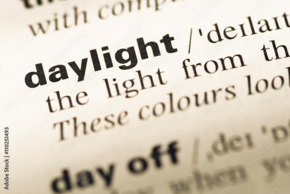 Obraz premium Close up of old English dictionary page with word daylight