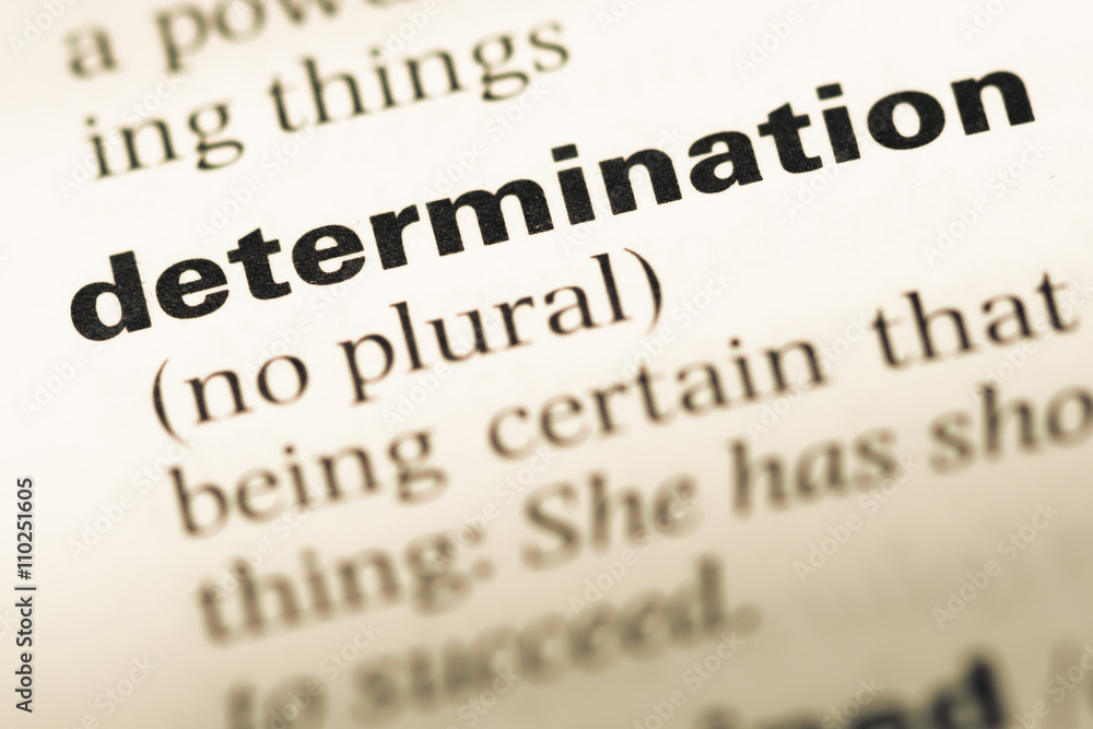 Close up of old English dictionary page with word determination Close up of old English dictionary page with word determination