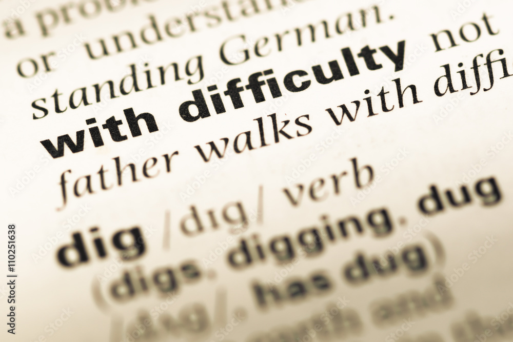 Close up of old English dictionary page with word with difficult Close up of old English dictionary page with word with difficult