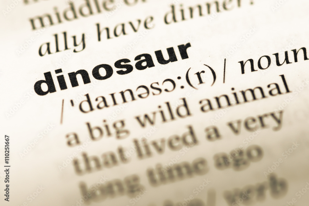 Close up of old English dictionary page with word dinosaur - obrazy, fototapety, plakaty 