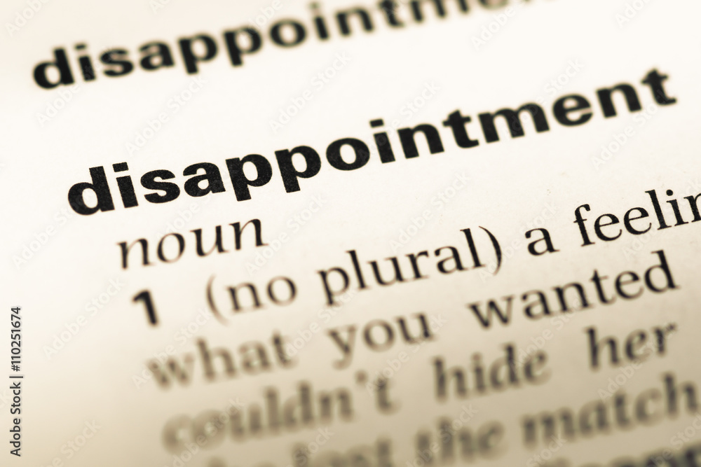 Close up of old English dictionary page with word disappointment Close up of old English dictionary page with word disappointment