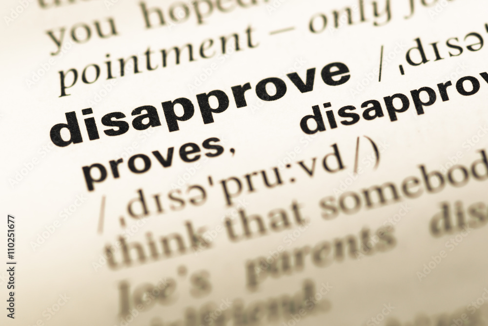 Close up of old English dictionary page with word disapprove Close up of old English dictionary page with word disapprove
