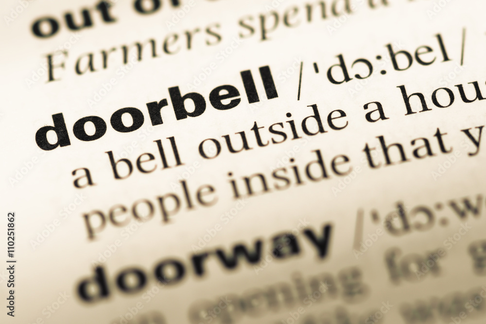 Close up of old English dictionary page with word doorbell Close up of old English dictionary page with word doorbell