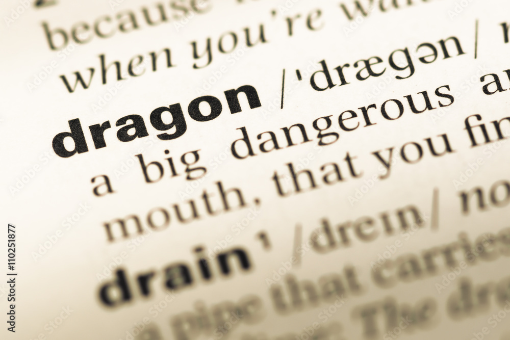 Close up of old English dictionary page with word dragon Close up of old English dictionary page with word dragon