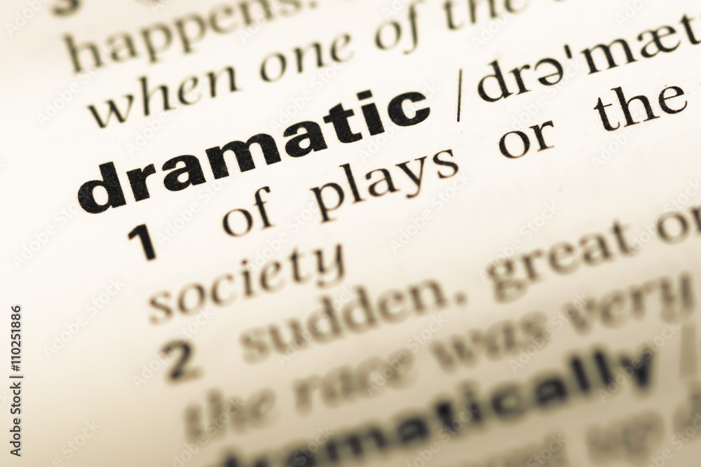 Close up of old English dictionary page with word dramatic Close up of old English dictionary page with word dramatic