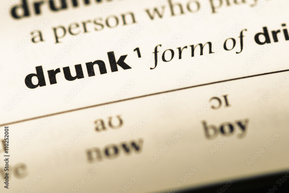 Close up of old English dictionary page with word drunk Close up of old English dictionary page with word drunk