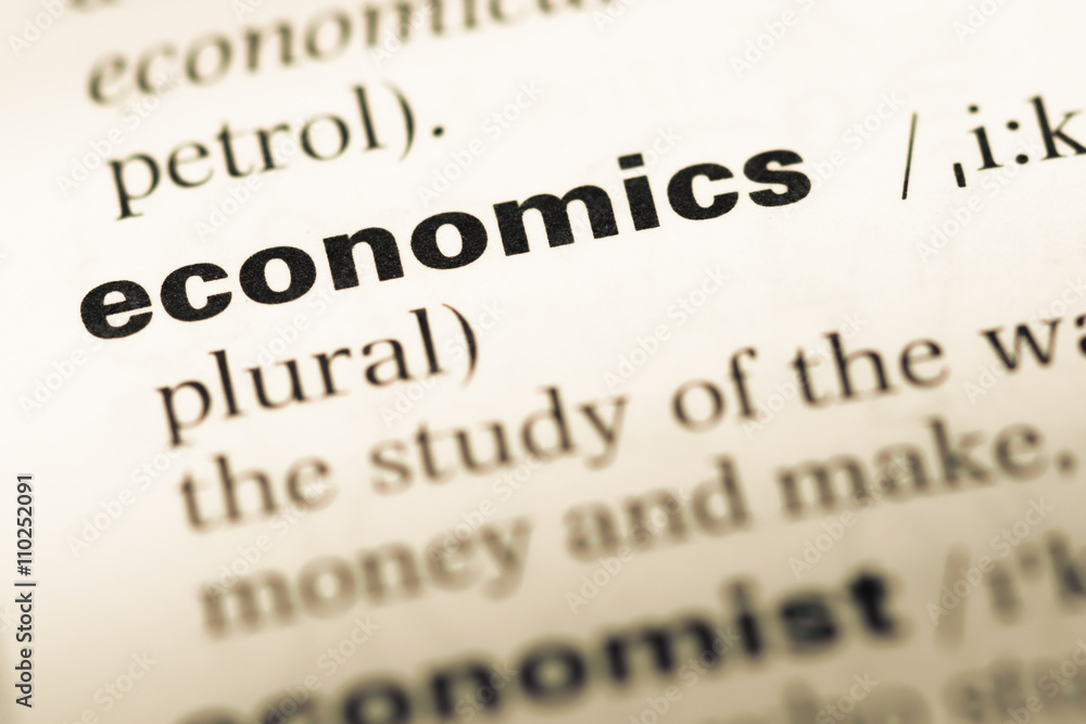 Close up of old English dictionary page with word economics Close up of old English dictionary page with word economics