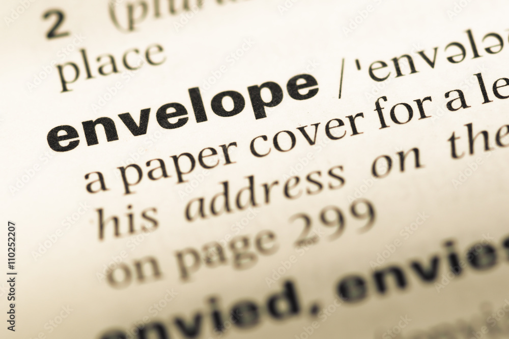 Obraz premium Close up of old English dictionary page with word envelope