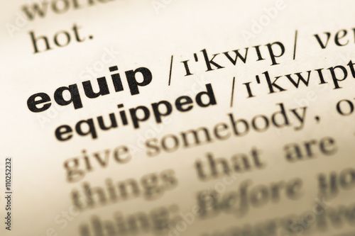 Close up of old English dictionary page with word equip