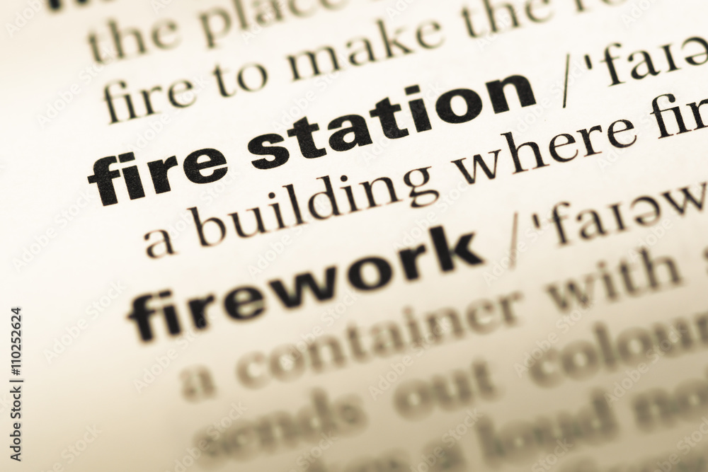 Close up of old English dictionary page with word fire station Close up of old English dictionary page with word fire station