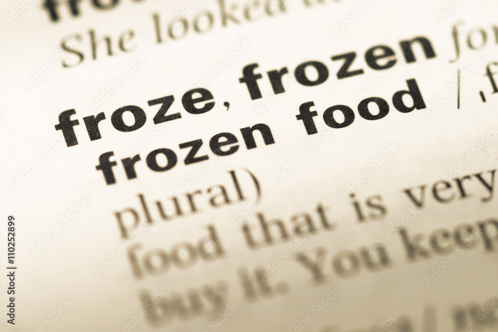 Close up of old English dictionary page with word froze frozen Close up of old English dictionary page with word froze frozen