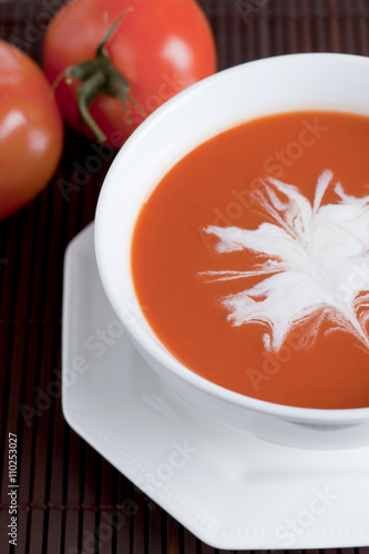 healthy tomato soup with tomatoes on the background