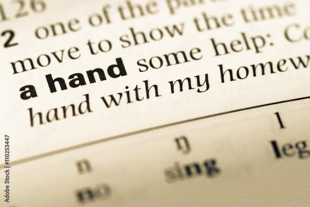 Close up of old English dictionary page with word a hand Close up of old English dictionary page with word a hand