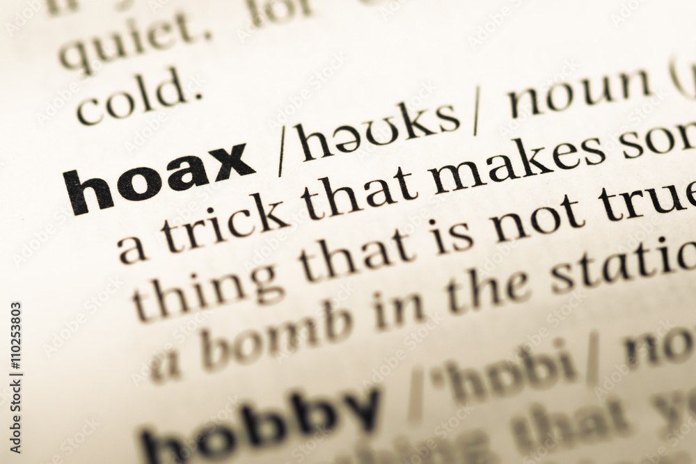 Close up of old English dictionary page with word hoax Close up of old English dictionary page with word hoax