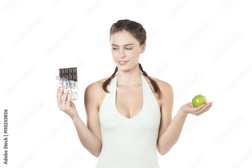 confused woman with apple and chocolate confused woman with apple and chocolate