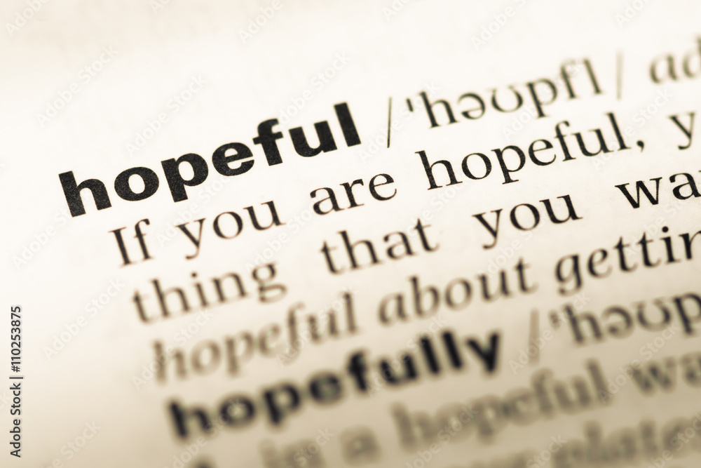 Close up of old English dictionary page with word hopeful Close up of old English dictionary page with word hopeful
