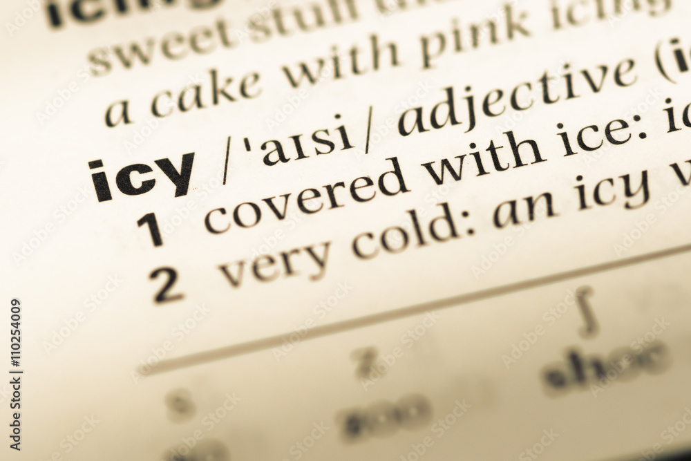 Close up of old English dictionary page with word icy Close up of old English dictionary page with word icy
