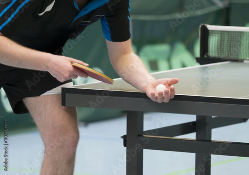 table tennis player serving, closeup