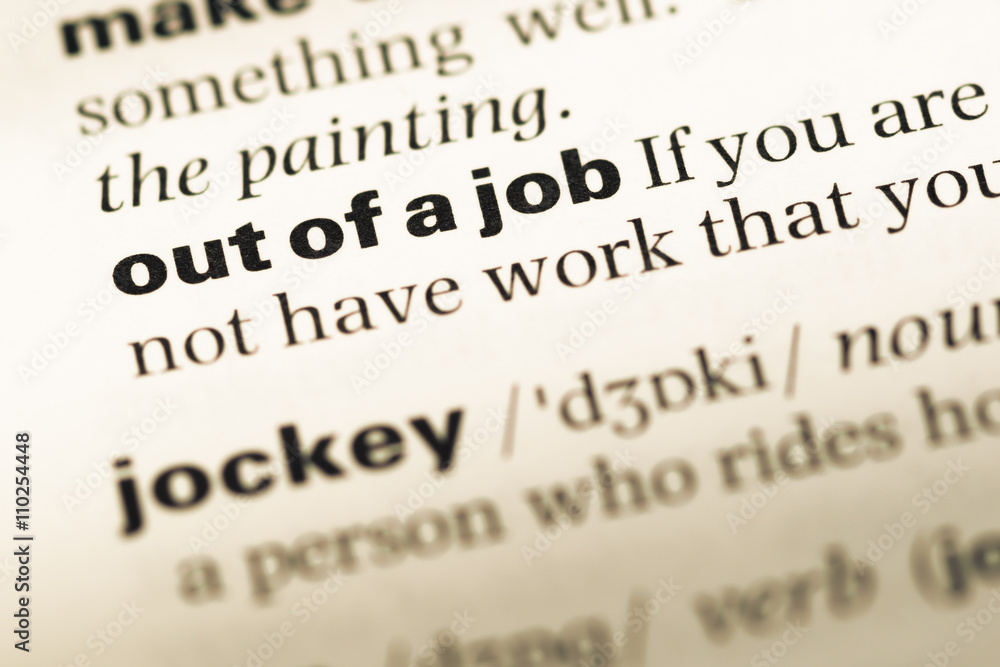Close up of old English dictionary page with word out of a job Close up of old English dictionary page with word out of a job