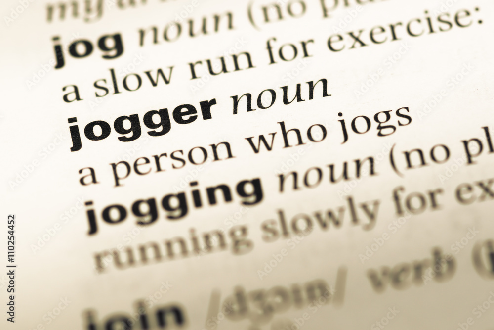Close up of old English dictionary page with word jogger Close up of old English dictionary page with word jogger