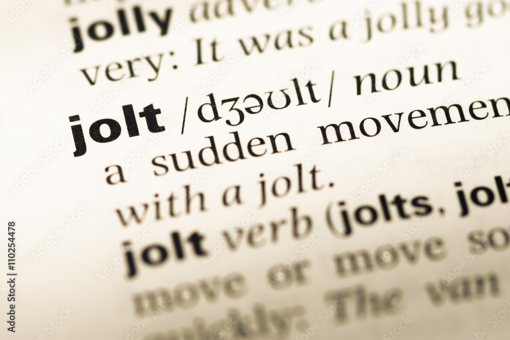Close up of old English dictionary page with word jolt Close up of old English dictionary page with word jolt