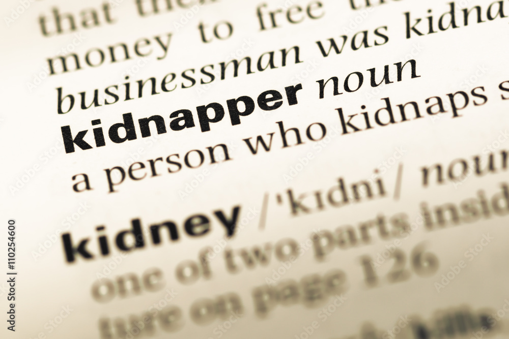Close up of old English dictionary page with word kidnapper Close up of old English dictionary page with word kidnapper
