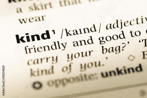 Close up of old English dictionary page with word kind