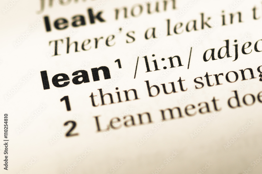 Close up of old English dictionary page with word lean