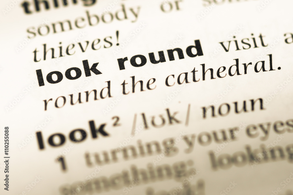 Close up of old English dictionary page with word look round Close up of old English dictionary page with word look round