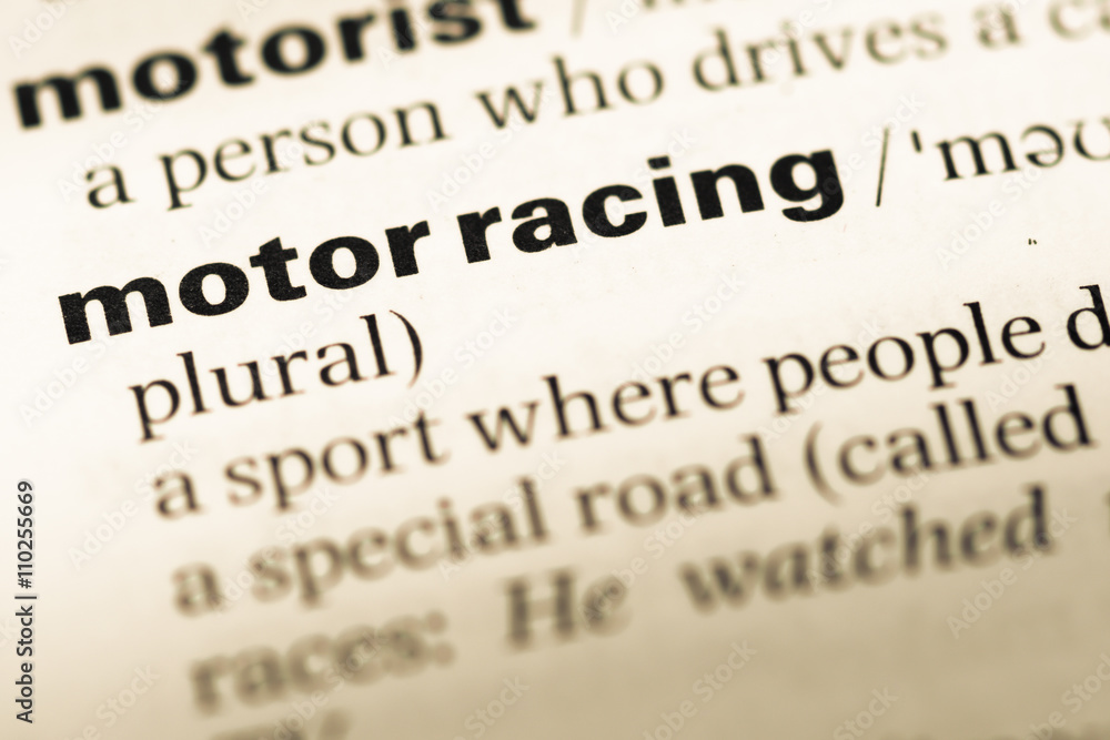 Obraz premium Close up of old English dictionary page with word motor racing